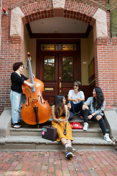 students with instruments on steps