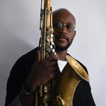 Gregory Groover, Black male wearing glasses and holding his saxophone