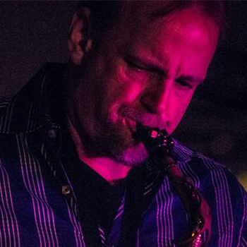 Scott Trach playing a saxophone.