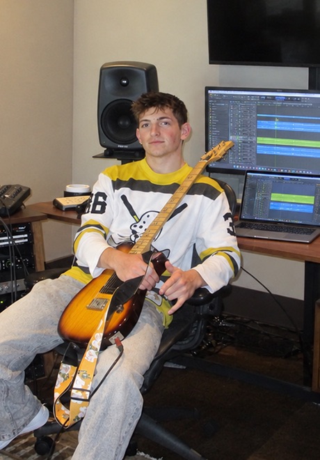 Jason Recht sits in a recording studio