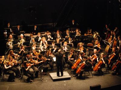 Aerial view of conductor leading an orchestra