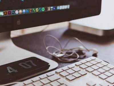 Workstation with an imac, keyboard, and smartphone