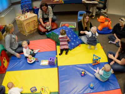 Aerial view of babies in a playgroup with mothers