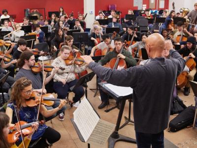 Conductor leading an orchestra practice