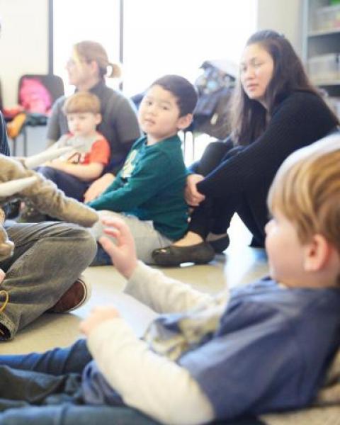 Teachers in a classroom using toys to instruct young children