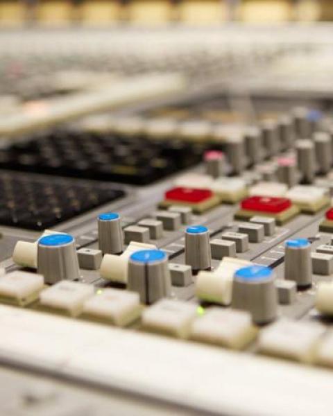 Complex analog mixing board with buttons and dials