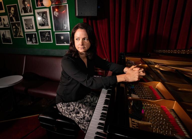 kris davis at a piano on the village vanguard stage