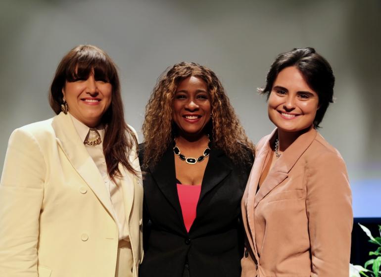 From left, Andreea Gleeson, Tonya Butler, and Hayley Roets pose for a picture on stage 