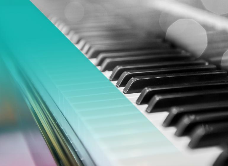 Black and white photo of a piano with a blue hue on the left