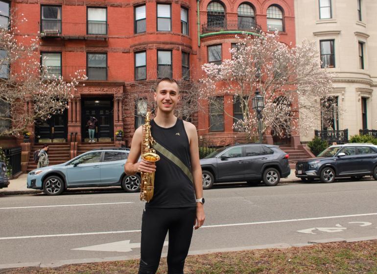 Xander Dawson with his saxophone on the Comm Ave Mall