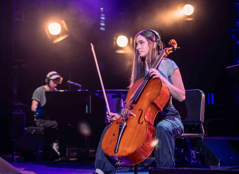Elaina Spiro playing the cello on stage