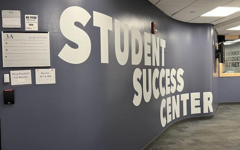 Hallway with a purple wall that says Student Success Center in large letters