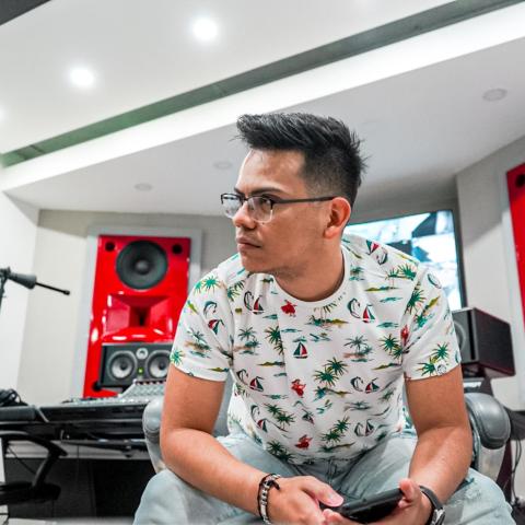 Kevin C Galvan sitting down