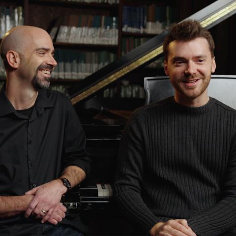  Leonardo and Peter Dugan sitting in front of a piano