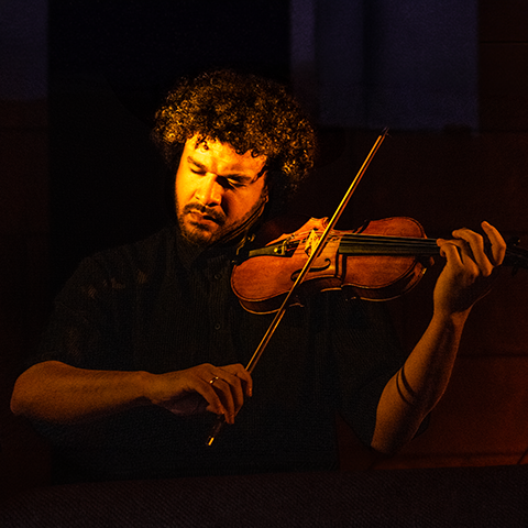 Curtis Stewart headshot, playing violin