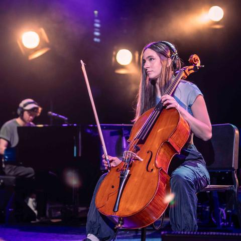 Elaina Spiro playing the cello on stage