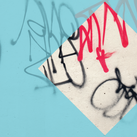 A wall with red and black graffiti. There is a blue hue overlay with a clear diamond cutout.