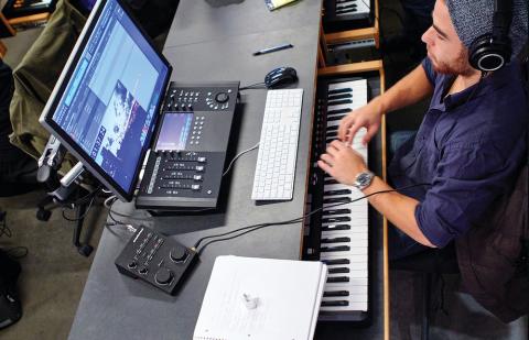 Student at a computer and a keyboard