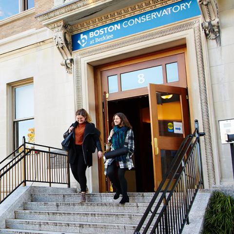 Conservatory students leaving an academic building