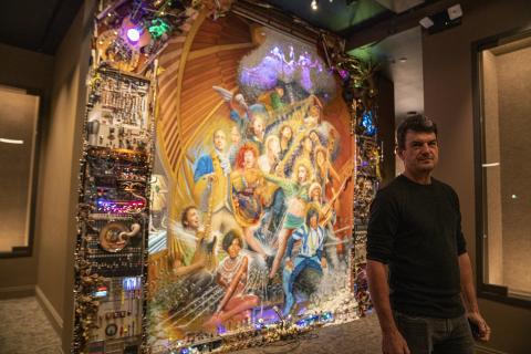 Photo of artist Mikel Glass and his mural at Berklee NYC
