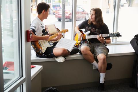 students playing instruments on windowsill 