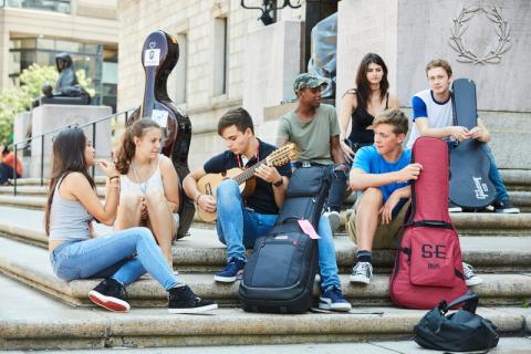 students playing instruments on steps