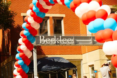 Balloon arch over a Berklee sign