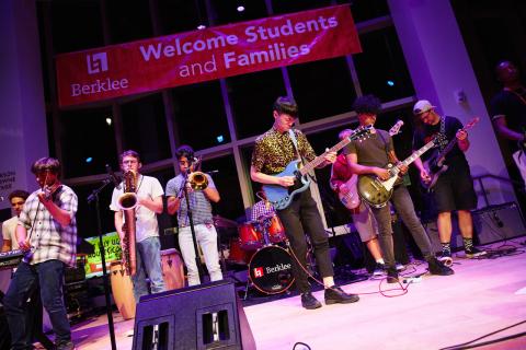 Students at Jam Session in front of Welcome Students and Families banner