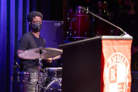 Johnathon Birch drums as part of a student performance during the ceremony
