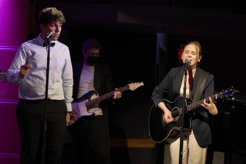 Students playing guitar and singing during the ceremony for Ringo Starr