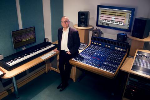 Joe Bennett standing in his music analysis studio 