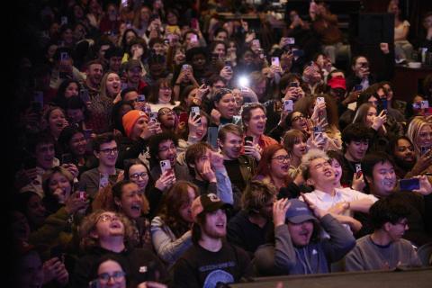 Visibly excited students in a packed auditorium waiting for Donald Glover to take the stage