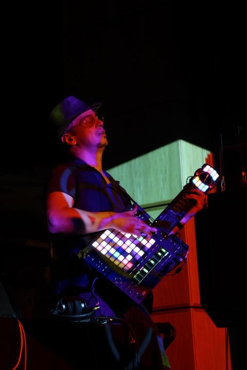 dan freeman playing a guitar-shaped array of MIDI controllers