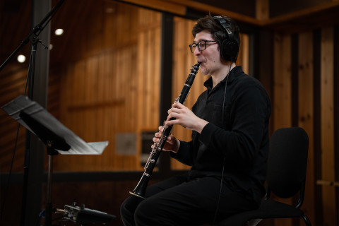 Daniel Meza (M.M. '23) records a clarinet solo at the Power Station studio. The recording session also featured a string orchestra composed of Boston Conservatory students performing original works by Berklee College of Music screen scoring students.