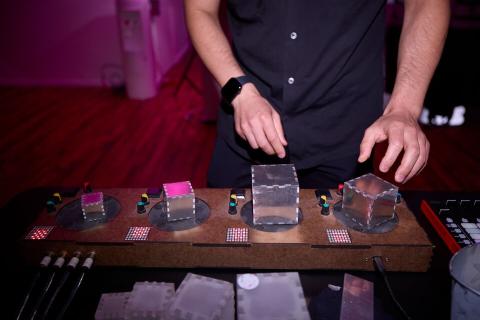 a custom tabletop instrument with four aluminum cubes on round pads