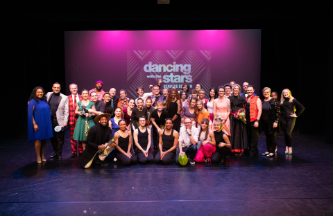 Chair of Dance Mila Thigpen (left) joins performers, coaches, and judges for a group photo.