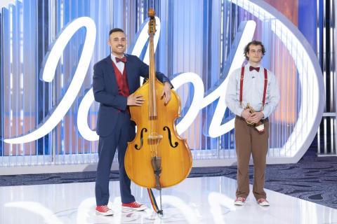 Colescott Rubin holds an acoustic bass on the American Idol audition stage alongside his brother A.J. who holds a trumpet.