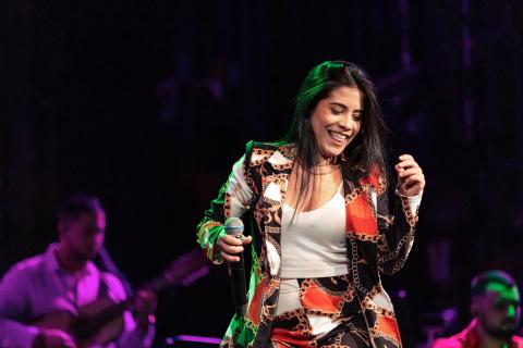 A woman vocalist dancing on stage