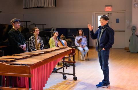  Lei Liang (far right) speaks with contemporary classical music students Ryan Chao, Keaton Shaw, Olivia Katz, and Clara Mazo (left to right).