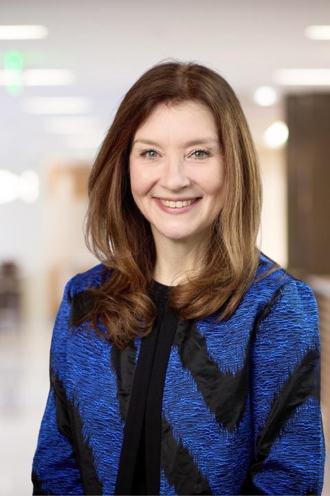 Portrait of a smiling Michele Darling wearing blue and black jacket.