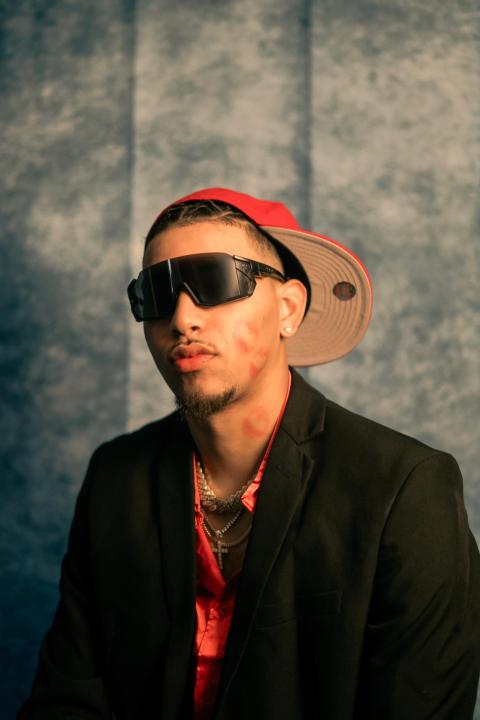 JimmyBoy posing in shades against a stylized gray backdrop 