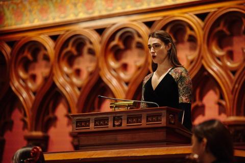 student singer at podium in a church