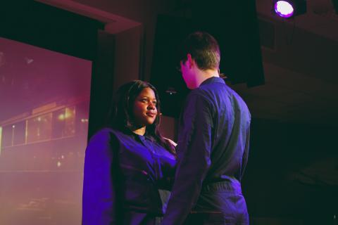 two people on stage talking to each other